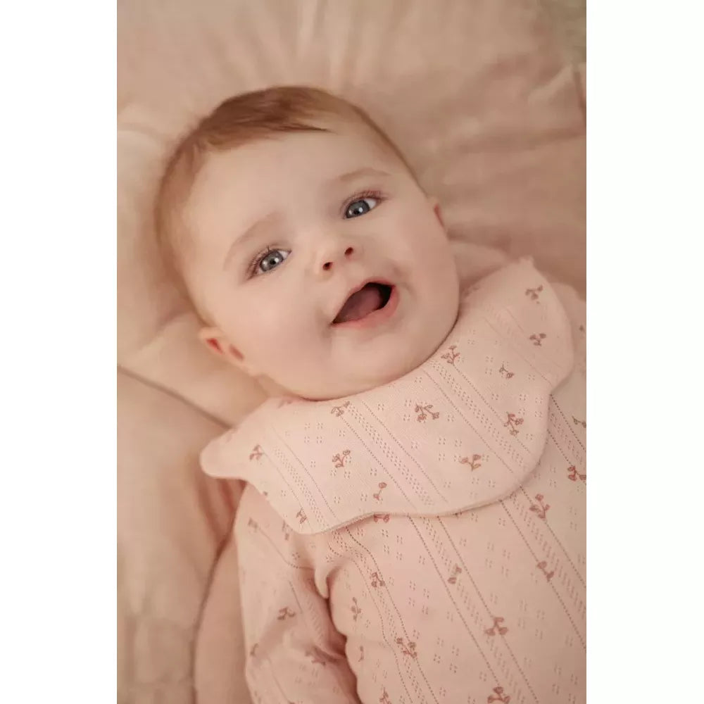 Bambina indossa il bavaglino chiaro del Set Bavaglini Fiore Rosa Little Dutch