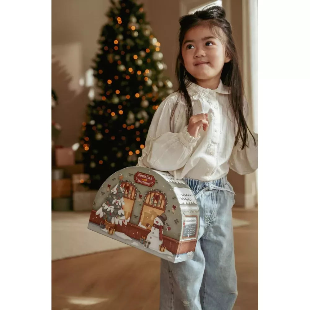 Bambina porta con sé la valigetta del Calendario dell'Avvento Trenino Little Dutch