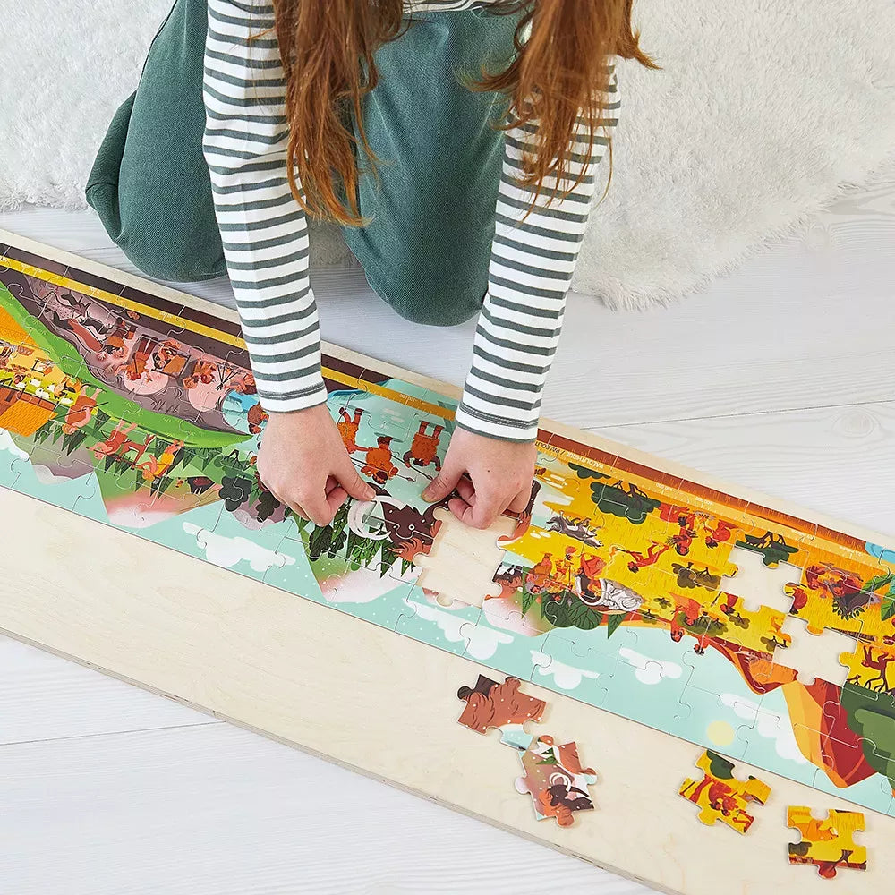 Bambina gioca con il Puzzle Fregio Preistorico 100 pezzi Janod 