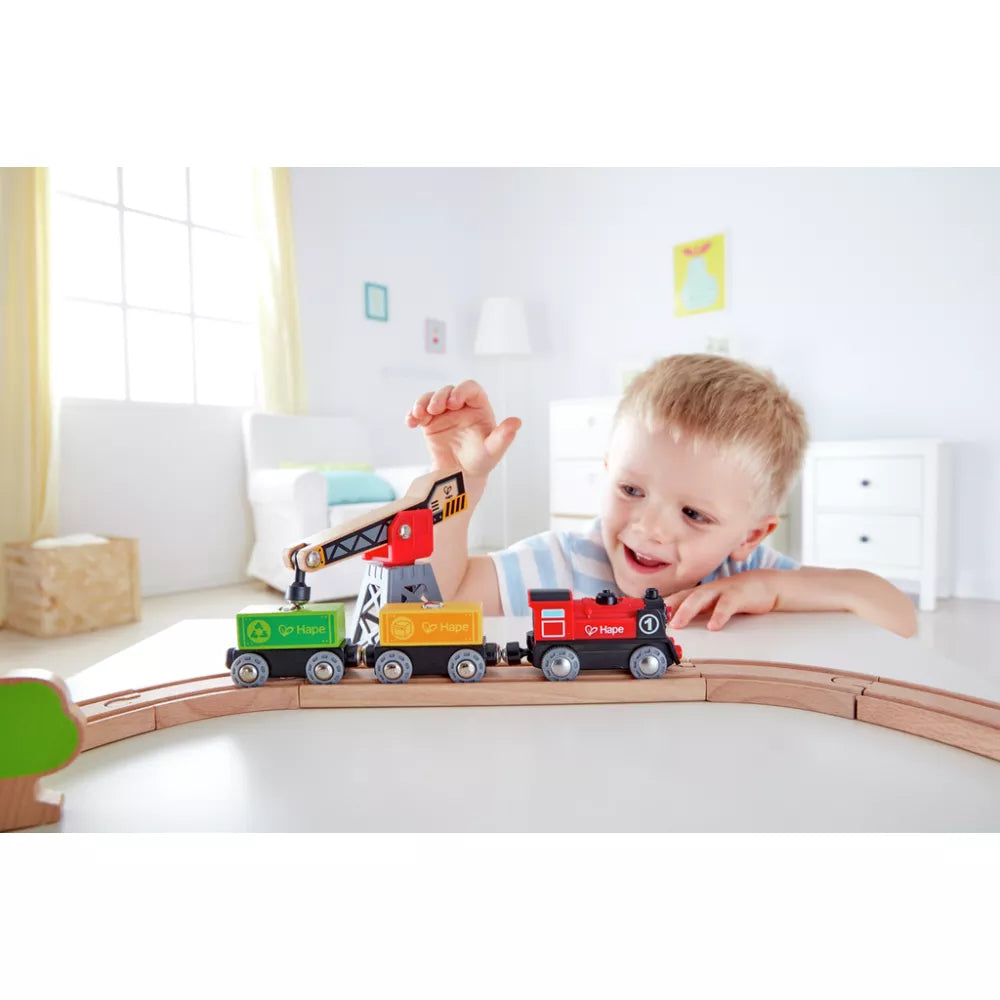 Bambino gioca con la Pista con Locomotiva a Batteria e Gru Hape