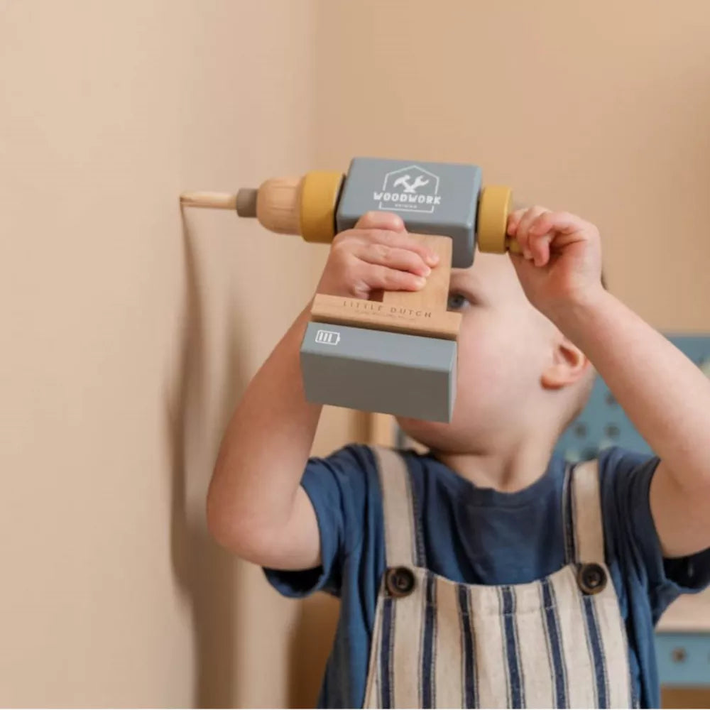Bambino finge di avvitare sul muro con il Trapano Little Dutch